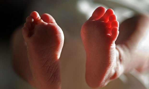 (FILE) In this file photograph taken on March 20, 2007, a two-week-old boy finds his feet in his ne...