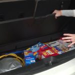 Extra snacks and drinks are stowed away beneath the cargo area, out of her kids’ reach. 