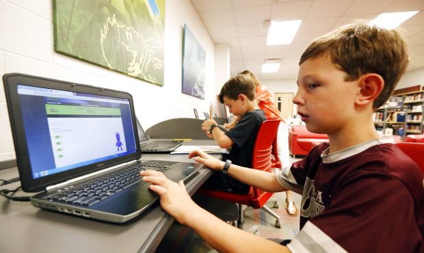 In this May 8, 2019, photo, third-grade student Miles Stidham uses an East Webster High School lapt...