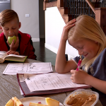 Liam and Lola Fowler eat a healthy snack as they do their after school home work.