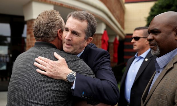 VIRGINIA BEACH, VIRGINIA - JUNE 01: Governor Ralph Northam (C) embraces a man who knew several of F...