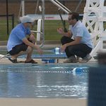 Officials testing the water at the pool. 