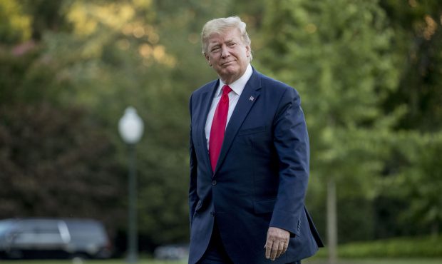 FILE - In this June 30, 2019 file photo, President Donald Trump walks across the South Lawn as he a...