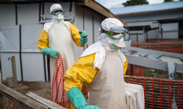 In this photograph taken Saturday July 13, 2019, health workers wearing protective suits take their...