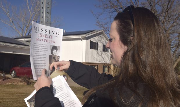 In this December 2018 photo, a victims advocate in Greeley, Colo. posts a flyer of a missing person...