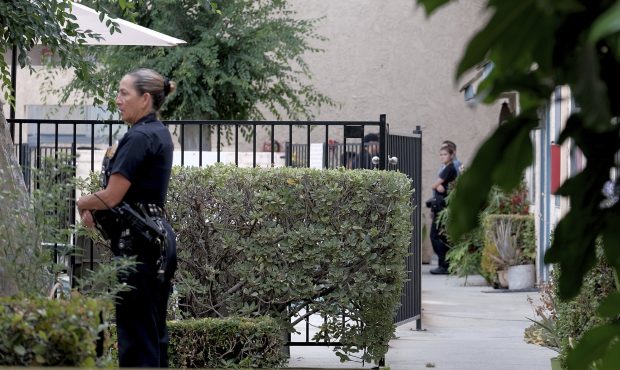 Los Angeles police officers guard an apartment where a shooting occurred in the Canoga Park area of...