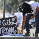 GILROY, CALIFORNIA - JULY 29: A woman leaves mementos at a makeshift memorial outside the site of the Gilroy Garlic Festival after a mass shooting took place at the event yesterday on July 29, 2019 in Gilroy, California.  Three victims were killed and at least a dozen were wounded before police officers killed the suspect. (Photo by Mario Tama/Getty Images)