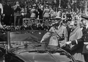 Nazi leader Adolf Hitler (1889 - 1945) inspects the new, Volkswagen 'people's car' at the Fallersleben car factory, 27th May 1938. The factory is designed to manufacture six million of the cars. On Hitler's left is the car's designer Dr Ferdinand Porsche (1875 - 1951). (Photo by Topical Press Agency/Hulton Archive/Getty Images)