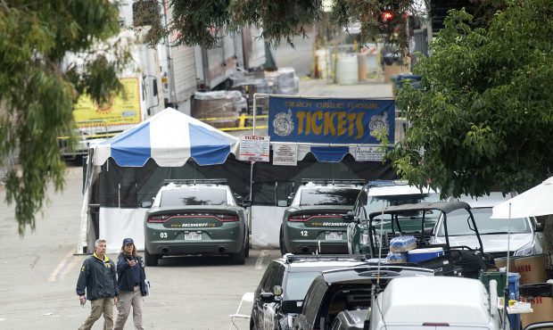 FILE - In this July 29, 2019 file photo FBI personnel pass a ticket booth at the Gilroy Garlic Fest...