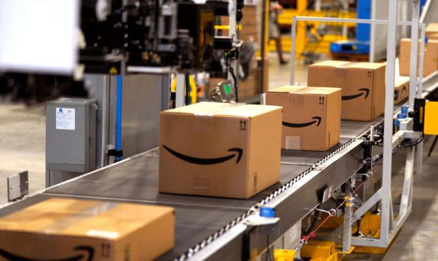 FILE: Packed orders move down a converyor belt at an Amazon fullfillment center. (Photo by Rick T. ...