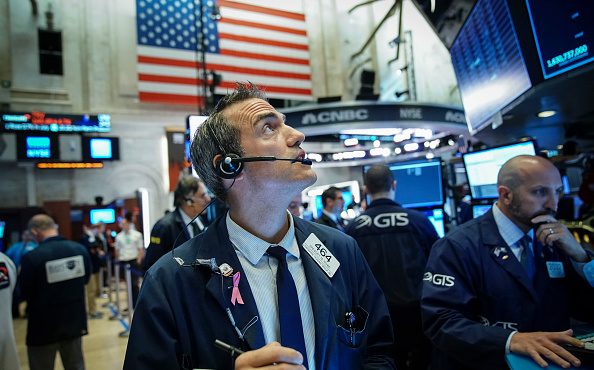 Traders and financial professionals work on the floor of the New York Stock Exchange (NYSE) at the ...