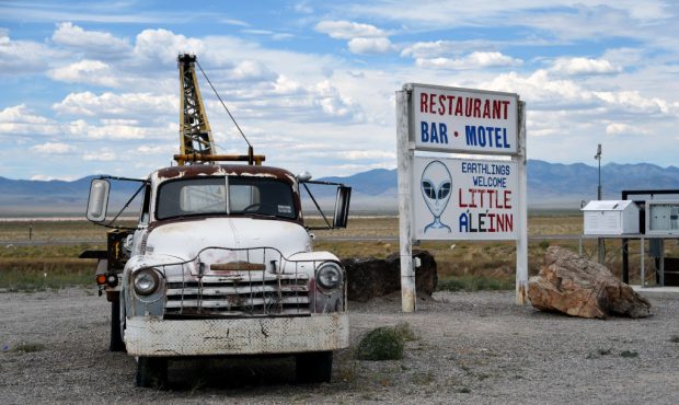 Roadside artwork featuring a tow truck and a flying saucer is displayed at the Little A'le' Inn res...