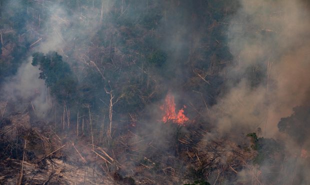 In this aerial image, a fire burns in a section of the Amazon rain forest on August 25, 2019 in the...
