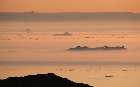 Icebergs float in Disko Bay at sunset on August 04, 2019 near Ilulissat, Greenland, during a heat w...