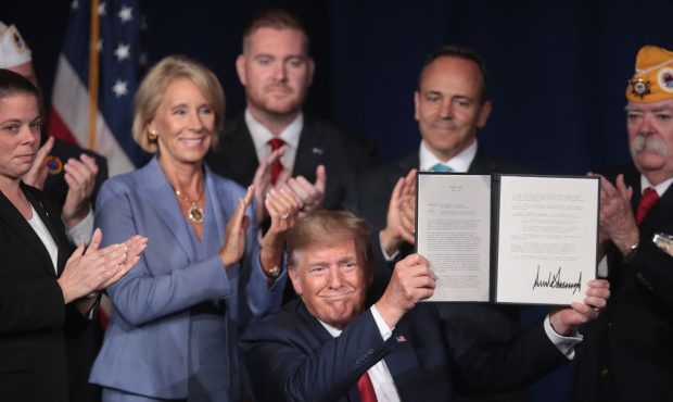 President Donald Trump signs a proclamation that will eliminate student loan debt for qualifying di...