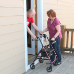Sue Jorgensen reminds her husband, Mike Jorgensen, to take a big step to get on their porch.