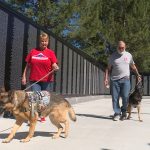 Linda and Jim Crismer walk their dogs along the memorial.
