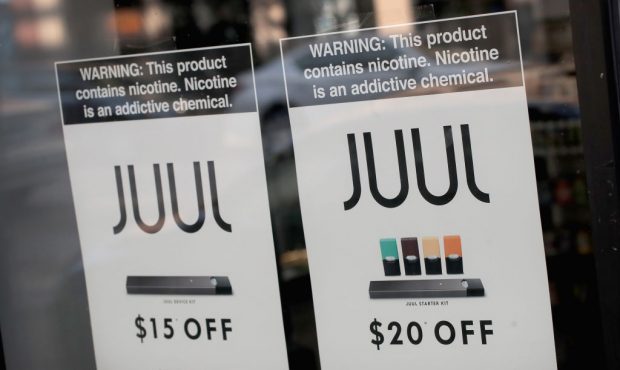 Signs in the window of the Smoke Depot advertise electronic cigarettes and pods by Juul, the nation...