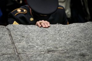 Army Reserve Sgt. Edwin Morales, who lost his friend and firefighter Ruben David Correa in the 9/11 attacks, pauses as he touches one of the stone monoliths following the dedication ceremony for the new 9/11 Memorial Glade at the National September 11 Memorial, May 30, 2019 in New York City. The 9/11 Memorial Glade honors the first responders who are sick or have died from exposure to toxins in the aftermath of the attacks and recovery efforts. The signature piece of the memorial are six stone monoliths that are inlaid with World Trade Center steel. (Photo by Drew Angerer/Getty Images)