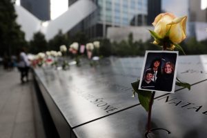 A picture is placed in a name along the National September 11 Memorial during a morning commemoration ceremony for the victims of the terrorist attacks Eighteen years after the day on September 11, 2019 in New York City. Throughout the country services are being held to remember the 2,977 people who were killed in New York, the Pentagon and in a field in rural Pennsylvania. (Photo by Spencer Platt/Getty Images)