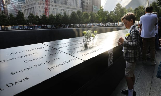 John Timson, 10, pauses at the National September 11 Memorial where his uncle Andrew Fisher's name ...
