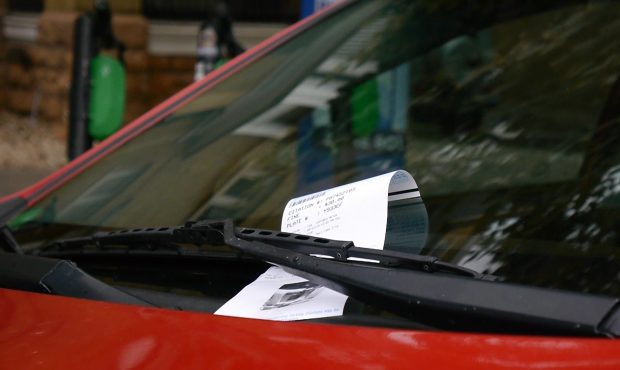 A parking citation sits on a windshield in Salt Lake City....