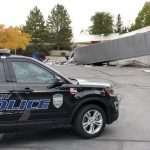 The driver of a semi truck was taken to the hospital in serious condition after the truck crashed over a retaining wall and into a church parking lot in Sandy on Oct. 10, 2019. (Photo: Derek Petersen)