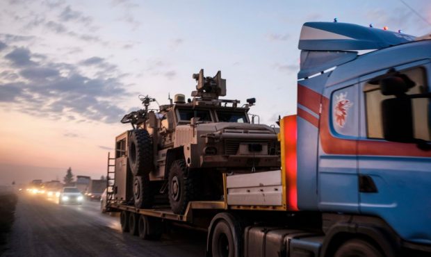 A convoy of U.S. armored military vehicles leave Syria on a road to Iraq on October 19, 2019 in She...