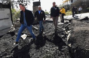 From left, California Governor Gavin Newsom, L.A. City Councilman Mike Bonin, and L.A. City Mayor Eric Garcetti tour a burned home along Tigertail Road in Brentwood, California on October 29.