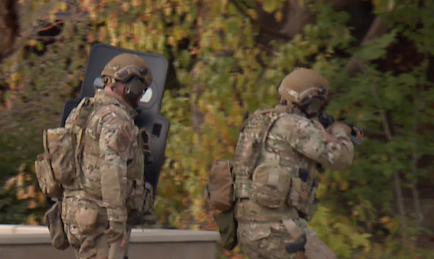 A SWAT team responds to a Murray home after a man allegedly assaulted a child before shooting at th...