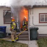 Firefighters working to put out a fire in a Salt Lake City home.  Courtesy Scott Jones