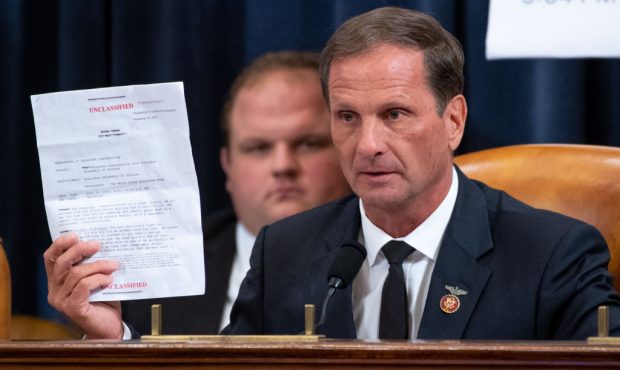 U.S. Rep. Chris Stewart (R-UT) holds up a copy of the transcript of a phone call between U.S. Presi...