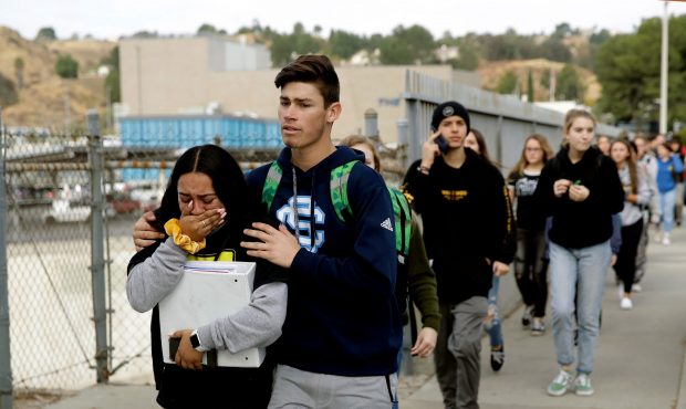 Students are escorted out of Saugus High School after the shooting. (Marcio Jose Sanchez / AP)...