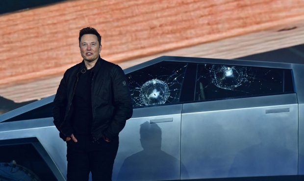 Tesla CEO Elon Musk stands in front of the shattered windows. (Tesla)...