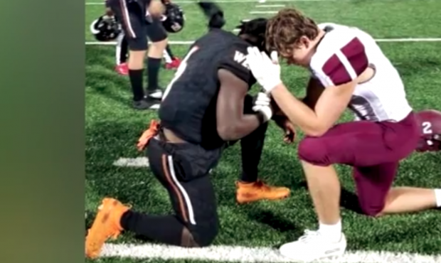 Opposing high school players went viral after they were photographed praying together after a game....
