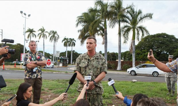 Rear Admiral Robert Chadwick answers questions at a press conference outside of the Nimitz Gate ent...