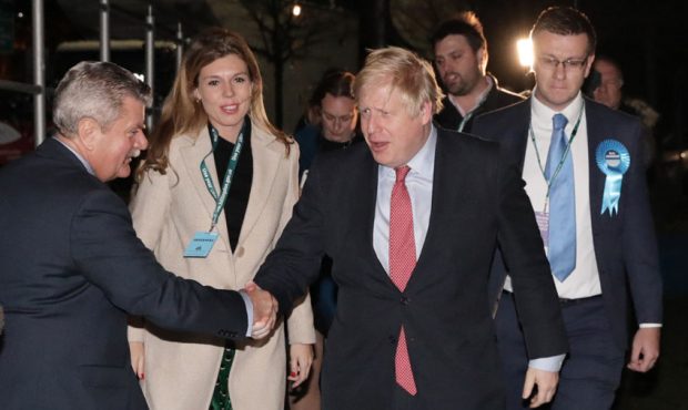 LONDON, ENGLAND - DECEMBER 13: Prime Minister Boris Johnson and his partner Carrie Symonds attend t...