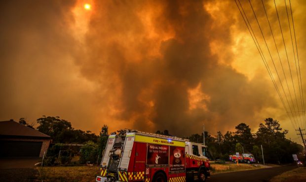 FILE: Firemen prepare as a bushfire approaches homes on the outskirts of the town of Bargo on Decem...