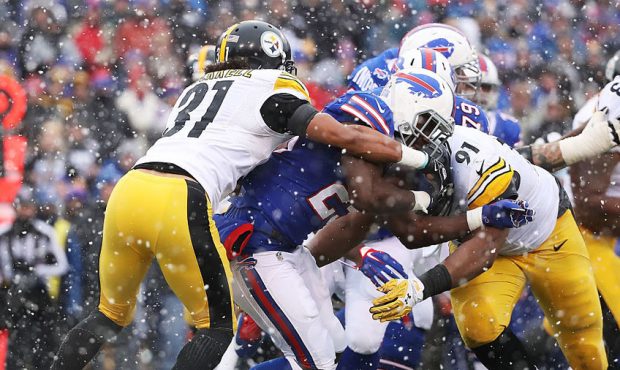 Stephon Tuitt #91 of the Pittsburgh Steelers tackles LeSean McCoy #25 of the Buffalo Bills during t...
