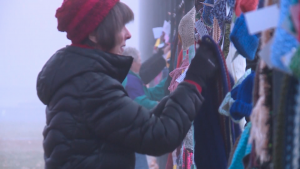 The group Scarfs in the Park hang handmade scarves and hats in Liberty Park form homeless people during the winter months.