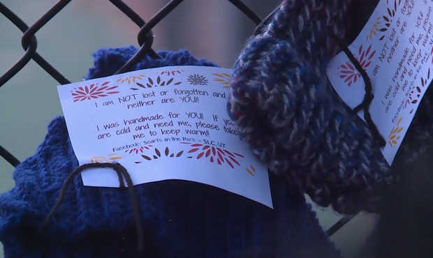 The group Scarfs in the Park hang handmade scarves and hats in Liberty Park form homeless people du...