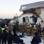 In this handout photo provided by the Emergency Situations Ministry of the Republic of Kazakhstan, police and rescuers work on the site of a plane crash near Almaty International Airport, outside Almaty, Kazakhstan, Friday, Dec. 27, 2019. Almaty International Airport said the Friday crash of a Bek Air plane in Kazakhstan caused numerous deaths. The aircraft had 100 passengers and crew abroad, and hit a concrete fence and a two-story building shortly after takeoff. ( Emergency Situations Ministry of the Republic of Kazakhstan photo via AP)