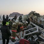 In this handout photo provided by the Emergency Situations Ministry of the Republic of Kazakhstan, police and rescuers work on the side of a plane crash near Almaty International Airport, outside Almaty, Kazakhstan, Friday, Dec. 27, 2019. Almaty International Airport said the Friday crash of the Bek Air plane in Kazakhstan has caused numerous deaths. The aircraft had 100 passengers and crew abroad, and hit a concrete fence and a two-story building shortly after takeoff. ( Emergency Situations Ministry of the Republic of Kazakhstan photo via AP)