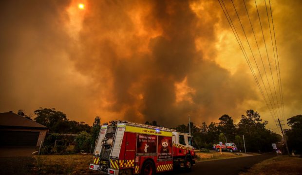 Firemen prepare as a bushfire approaches homes on the outskirts of the town of Bargo on December 21, 2019 in Sydney, Australia. A catastrophic fire danger warning has been issued for the greater Sydney region, the Illawarra and southern ranges as hot, windy conditions continue to hamper firefighting efforts across NSW. NSW Premier Gladys Berejiklian declared a state of emergency on Thursday, the second state of emergency declared in NSW since the start of the bushfire season. (Photo by David Gray/Getty Images)