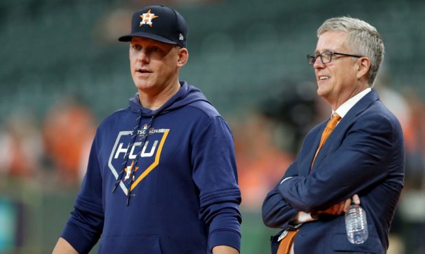 FILE: Manager AJ Hinch #14 talks with Jeff Luhnow, General Manager of the Houston Astros, prior to ...
