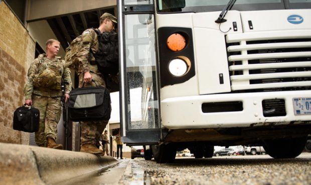 U.S. troops from the Army's 82nd Airborne Division board a bus as they head out for a deployment to...