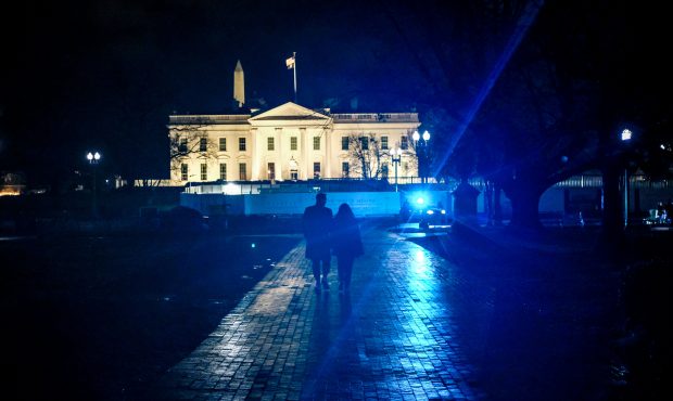 WASHINGTON, DC - JANUARY 07: A couple holds hands while walking outside the White House on January ...