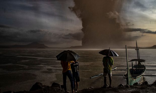 Residents look on as Taal Volcano erupts on January 12, 2020 in Talisay, Batangas province, Philipp...