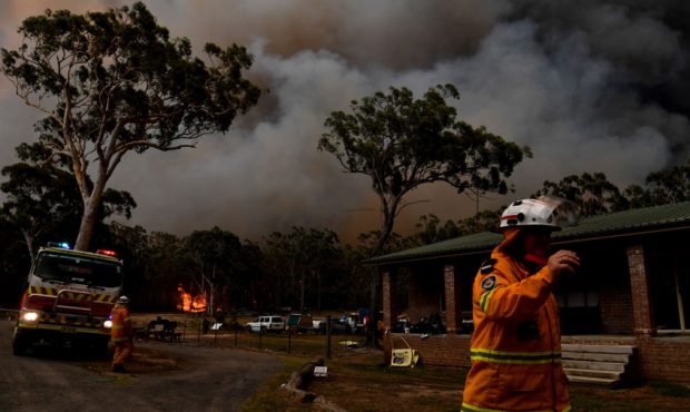 Rural Fire Service (RFS) firefighters conduct property protection near the Australian town of Susse...
