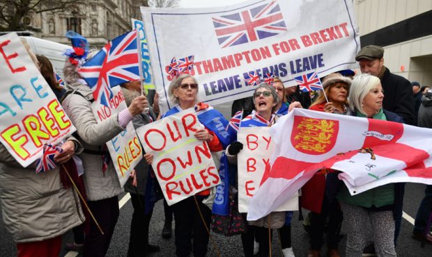 LONDON, ENGLAND - JANUARY 31: Pro Brexit supporters wave Union Jack flags while standing on a Europ...